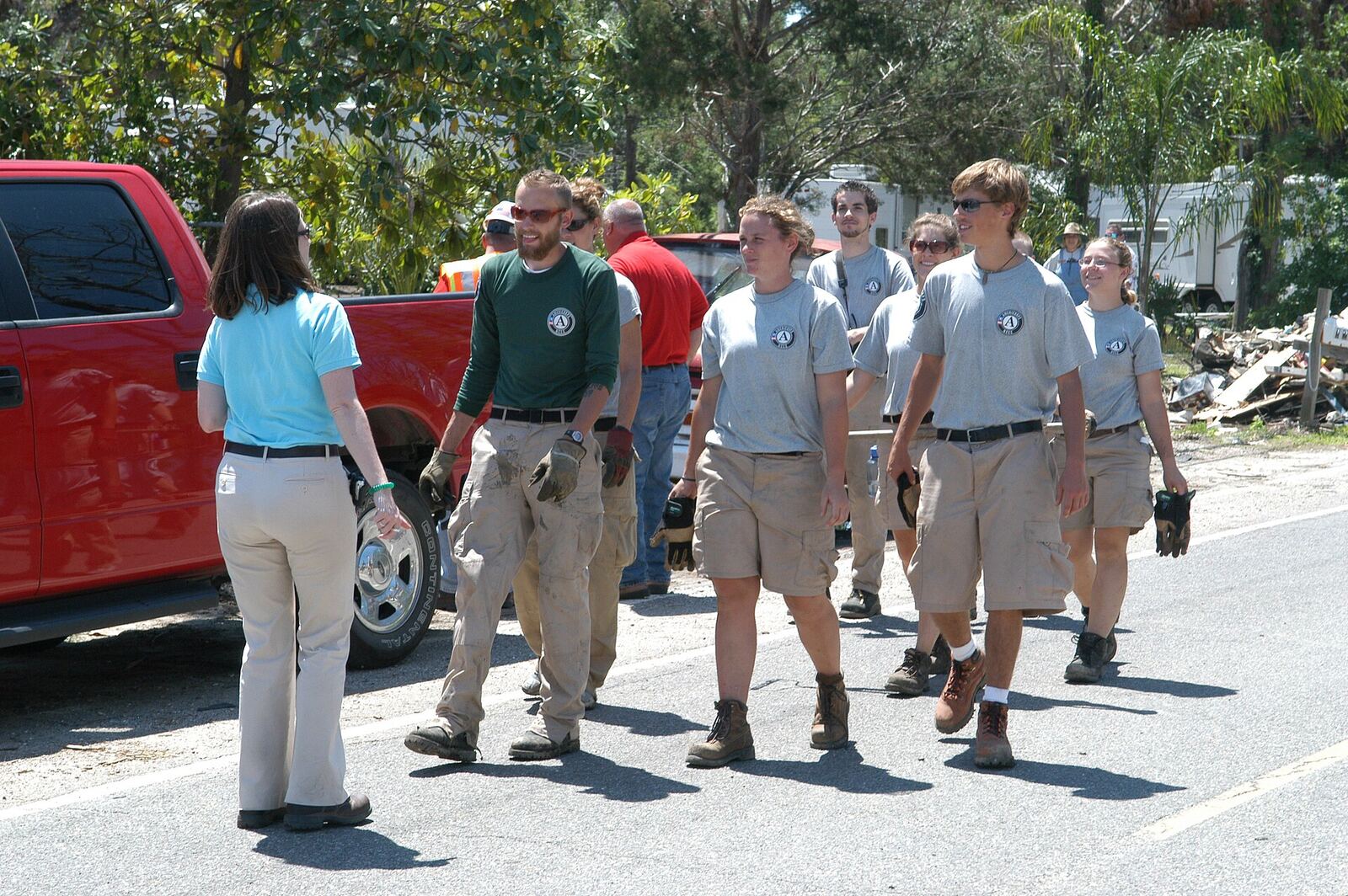 Disaster Relief | The Life After Tragedy Volunteers assist with disaster relief, walking near debris after a catastrophe.