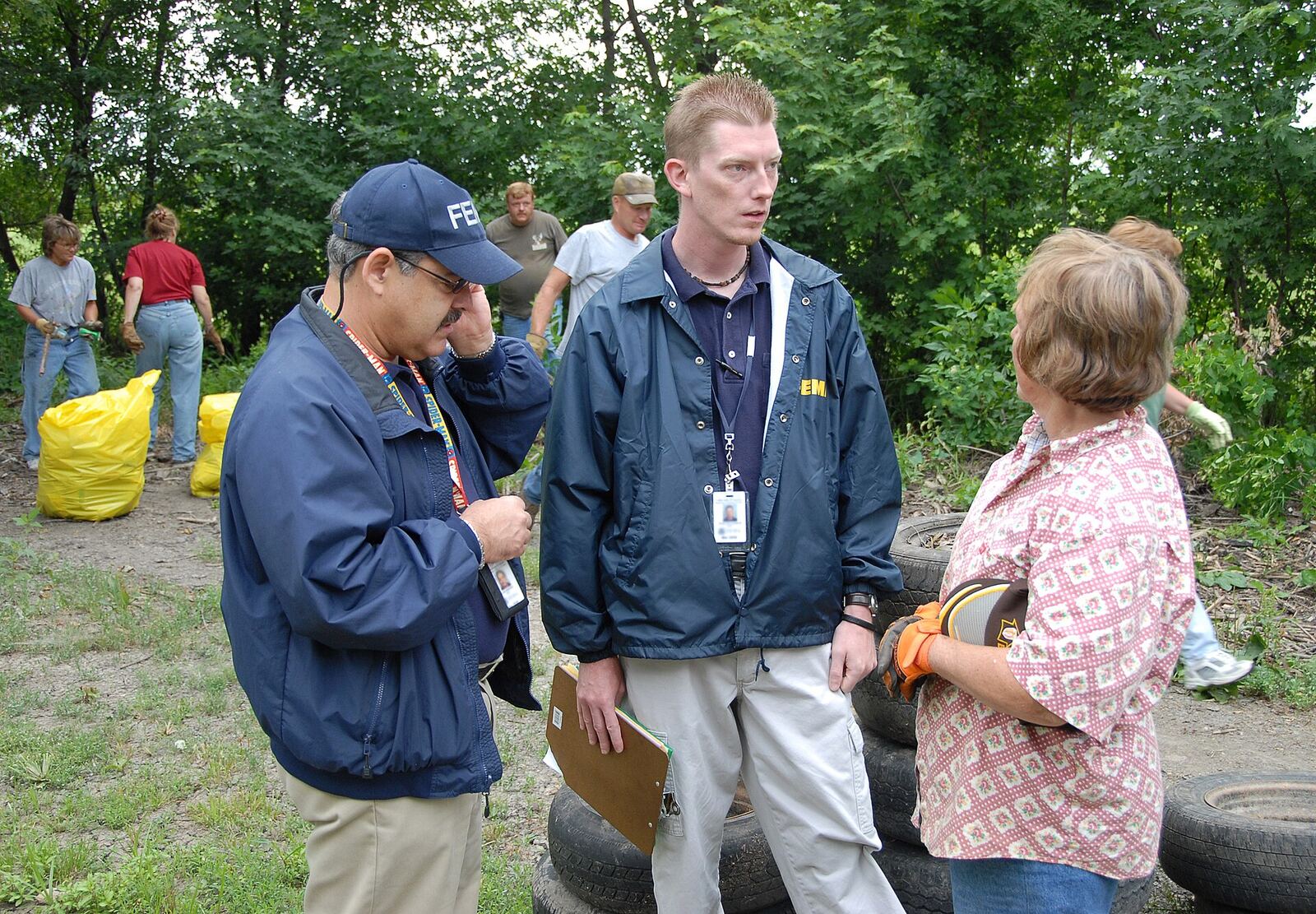 Crime Scene Investigation | The Life After Tragedy FBI investigators discuss details at a wooded crime scene, highlighting catastrophe archive work.